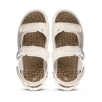 Pair of beige sandals with textured soles on a white background