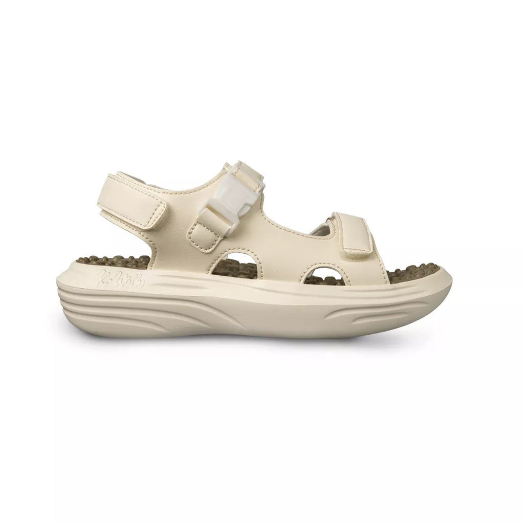 Beige sandal with a white strap on a white background