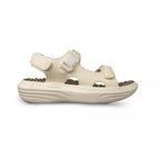 Beige sandal with a white strap on a white background