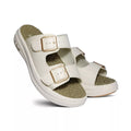 White sandals with brown buckles on a white background
