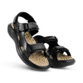 Black sandals with beige soles on a white background