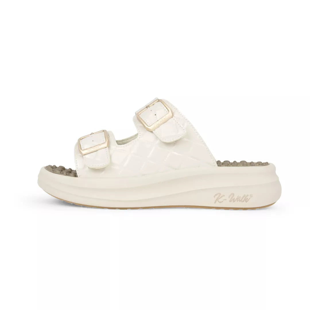 White sandal with gold buckles on a white background
